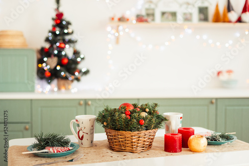 Light Olive Kitchen Decorated for the New Year. Table is festively set for Christmas.