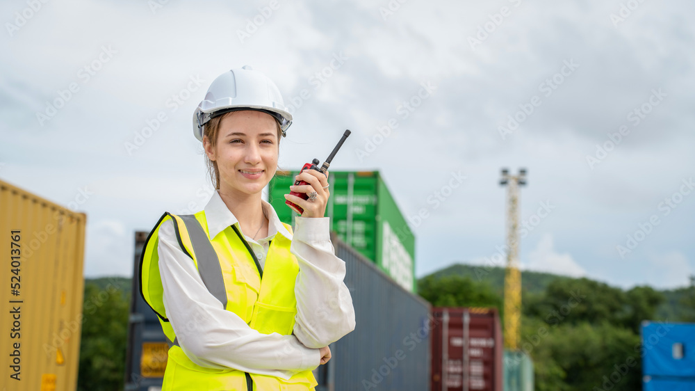 Woman foreman smile using walkie talkie in front of Cargo forklift in warehouse , Manager in white helmet Safety Supervisor in Container Custom Terminal port concept import export Woman foreman smile using walkie talkie in front of Cargo forklift in warehouse , Manager in white helmet Safety Supervisor in Container Custom Terminal port concept import export