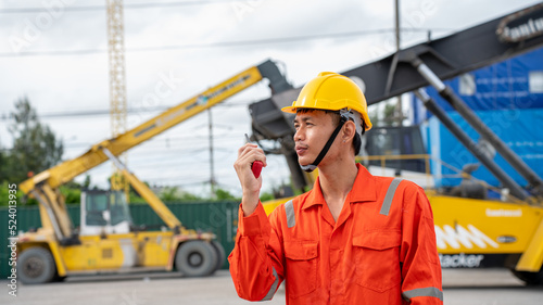 Foreman smile at side of Cargo forklift in warehouse in Container Custom Terminal port concept import export