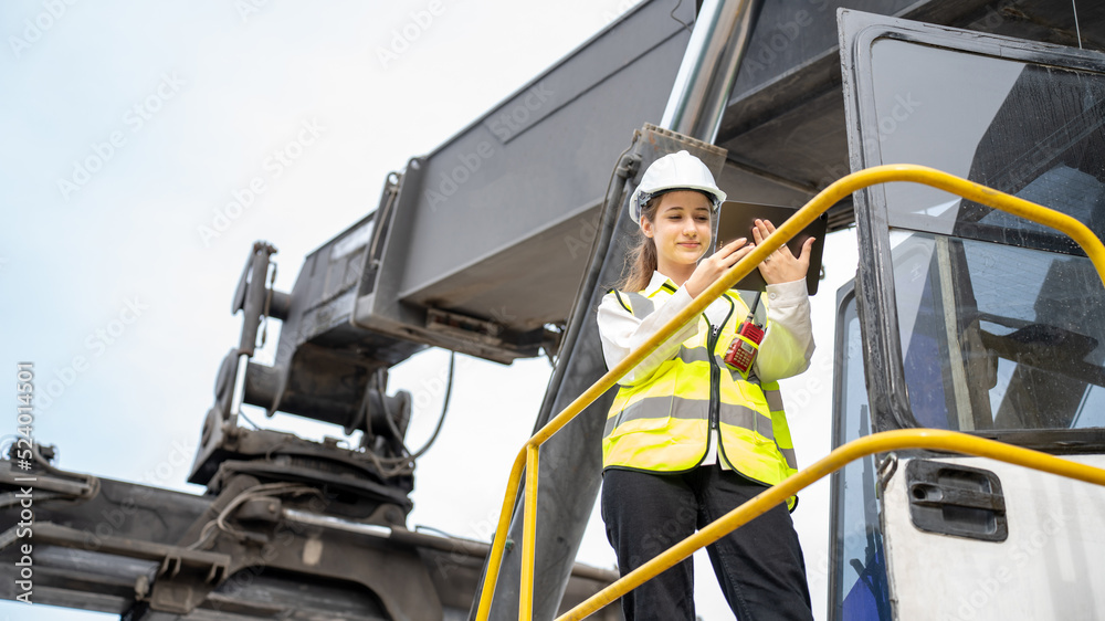 Female Foreman stay on lifting forklift container cargo forklift check or inspect and control forklift concept service and transportation logistic. Foreman using tablet for Daily Check Before Working Female Foreman stay on lifting forklift container cargo forklift check or inspect and control forklift concept service and transportation logistic. Foreman using tablet for Daily Check Before Working