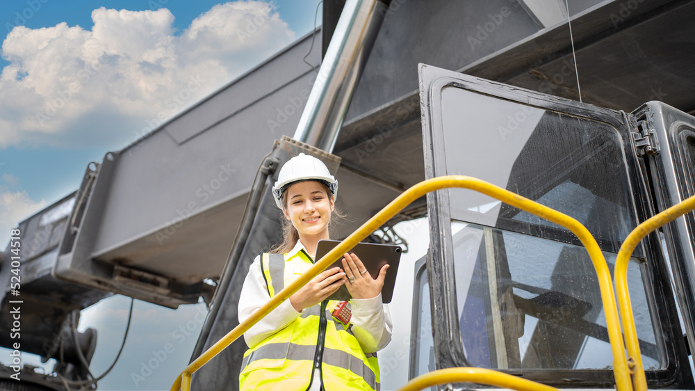 Female Foreman stay on lifting forklift container cargo forklift check or inspect and control forklift concept service and transportation logistic. Foreman using tablet for Daily Check Before Working Female Foreman stay on lifting forklift container cargo forklift check or inspect and control forklift concept service and transportation logistic. Foreman using tablet for Daily Check Before Working
