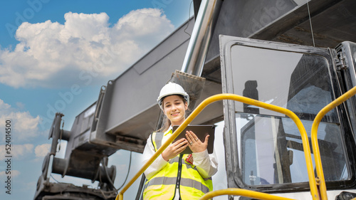 Female Foreman stay on lifting forklift container cargo forklift check or inspect and control forklift concept service and transportation logistic. Foreman using tablet for Daily Check Before Working