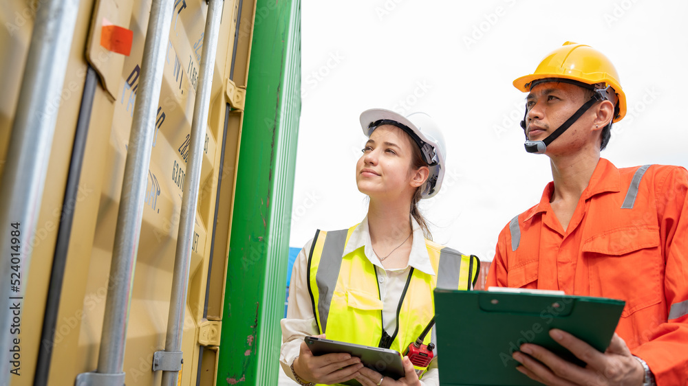 Woman Manager and Foreman Checking Cargo in Container cargo CustomTerminal port, Manager use Tablet for checking cargo concept import export transportation and logistic insurance service Woman Manager and Foreman Checking Cargo in Container cargo CustomTerminal port, Manager use Tablet for checking cargo concept import export transportation and logistic insurance service
