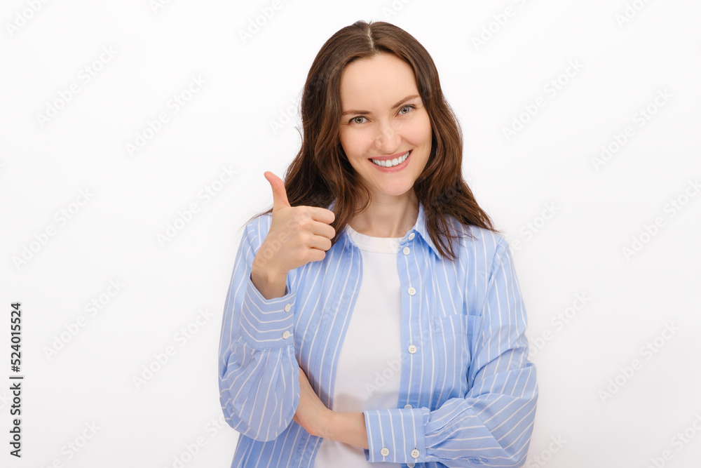 smiling portrait of woman in blue shirt shows gesture thumbs up on white background, smiling portrait of woman in blue shirt shows gesture thumbs up on white background,