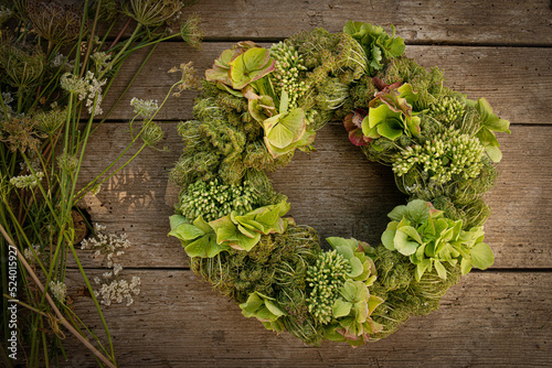 Flower wreath on wooden background photo