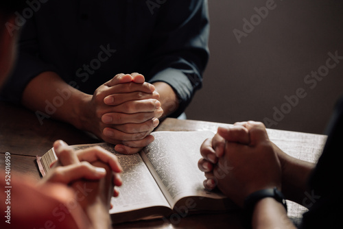 Christian group are praying to god with the bible and sharing the gospel. Concept of faith for god. © Kannapat