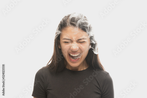 Bild auf Leinwand Shouting young girl with dark hair releases smoke from the mouth isolated over white background