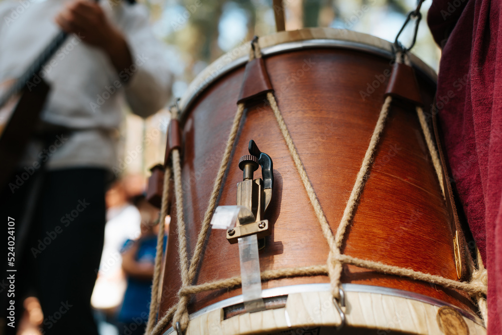 Musician playing ethnic drum folk music at outdoor entertainment. Close-up, selective focus