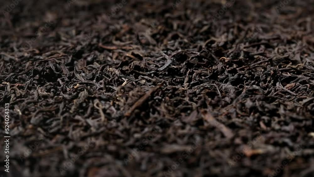 Falling dried black tea leaves close up. Macro. view on turntable Falling dried black tea leaves close up. Macro. view on turntable
