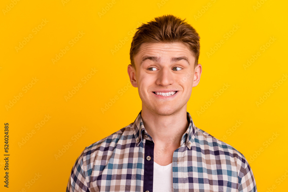 Photo of young excited man curious look empty space dream think idea isolated over yellow color background Photo of young excited man curious look empty space dream think idea isolated over yellow color background