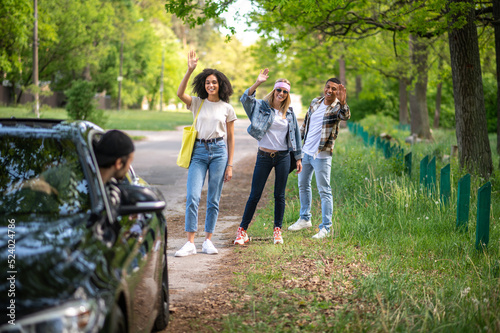 Group of young people on the road in the forest