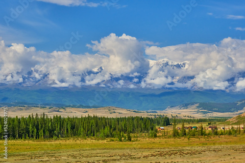 clouds and a snow-covered mountain range