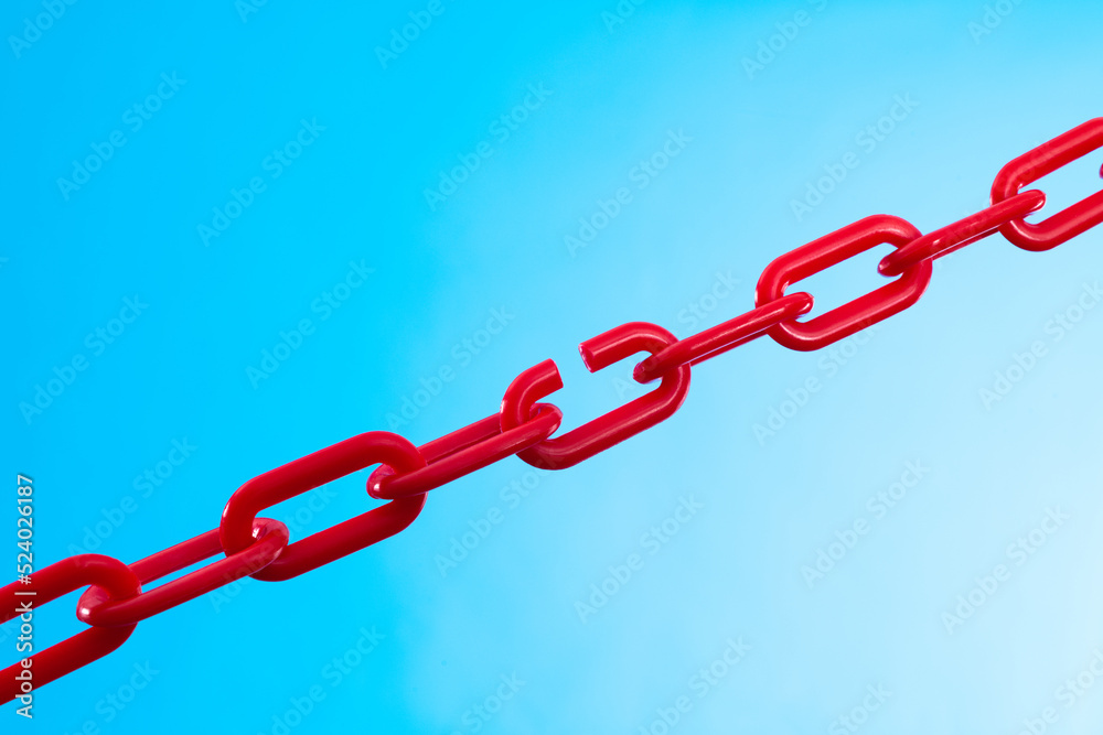 Fototapeta premium Red plastic chain on blue background
