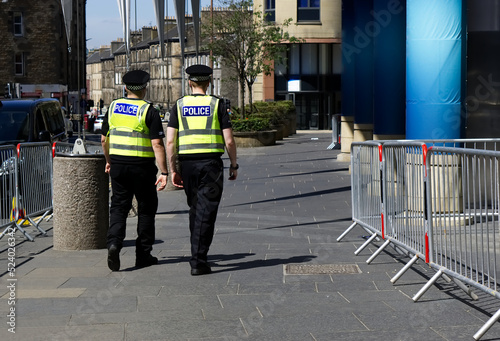 Police officer on duty on a city centre street during special event. 