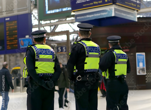 Police officer on duty on a city centre street during special event.  photo