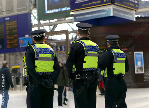 Police officer on duty on a city centre street during special event. 