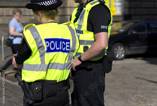 Police officer on duty on a city centre street during special event.  photo