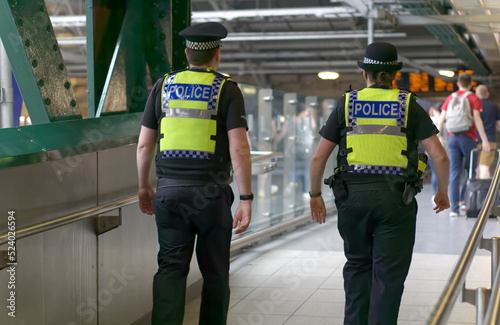 Police officer on duty on a city centre street during special event. 