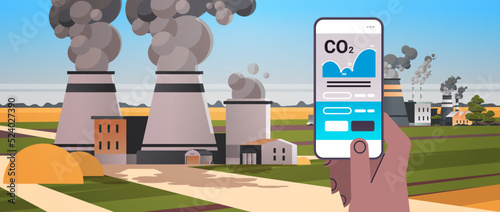 hand using carbon credits mobile app on smartphone screen responsibility of co2 emission environmental conservation
