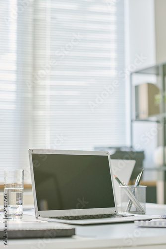 Close-up of laptop for online work standing on table at modern office