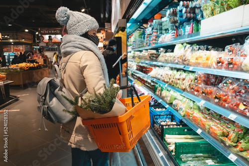 woman in winter outfit do groceries shopping