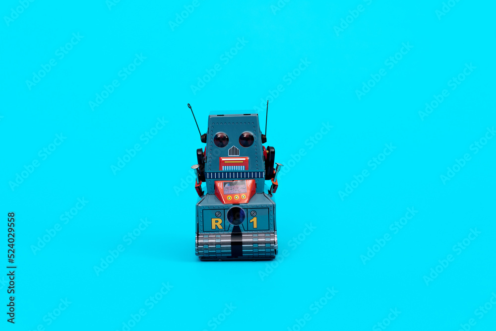 Retro robot toy on blue background