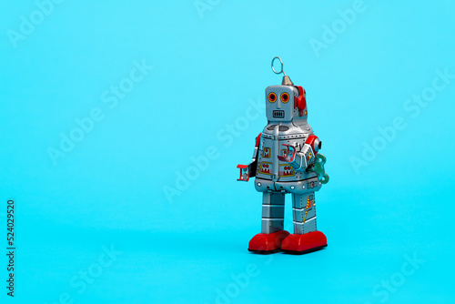 Retro robot toy on blue background