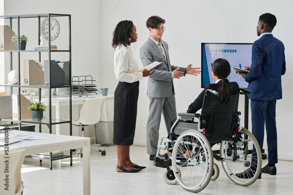 Group of business people working in team discussing new business plan during presentation at office Group of business people working in team discussing new business plan during presentation at office