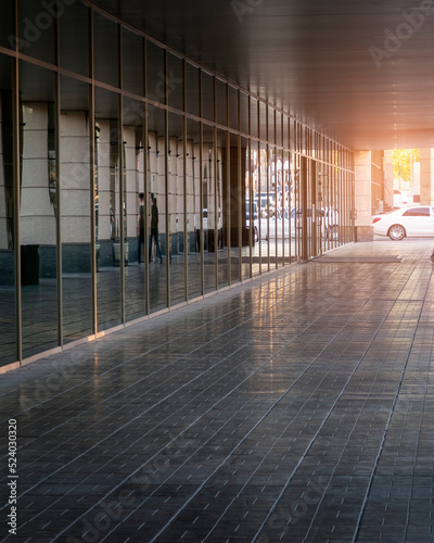 Street path with reflection wall. White car at the exit. Selective focus. Copy space for text