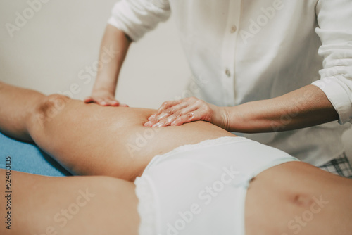 female masseuse giving a massage to a client in her beauty center