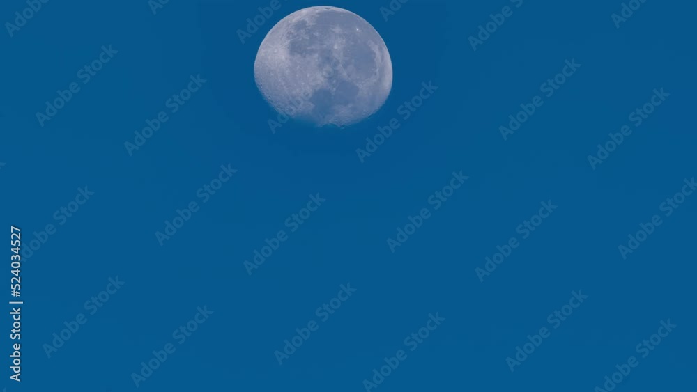 Full moon is moving across light clear blue sky background Time Lapse,Amazing moon High quality footage Timelapse Full moon is moving across light clear blue sky background Time Lapse,Amazing moon High quality footage Timelapse
