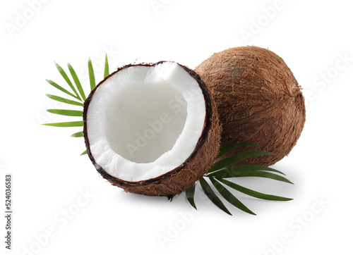 Fresh ripe coconuts with palm leaves isolated on white