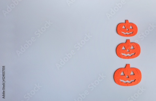 Three Beautiful pumpkin on a grey background. Creative halloween concept backdrop. halloween pumpkin craft.