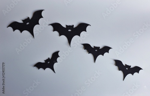 Five silhouettes of bats on a gray background. Creative halloween concept backdrop. halloween bats craft.