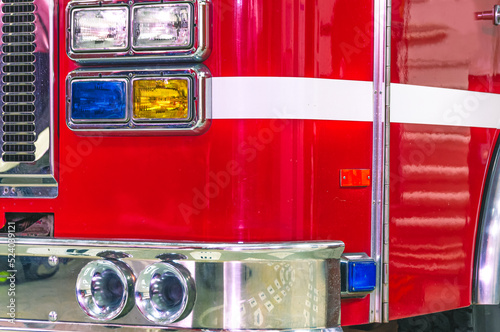 A special sound signal of a fire truck. View of the fire truck from the front. Shiny chrome fire truck parts. Fire truck headlights. The front part of the cab of the fire truck headlights.