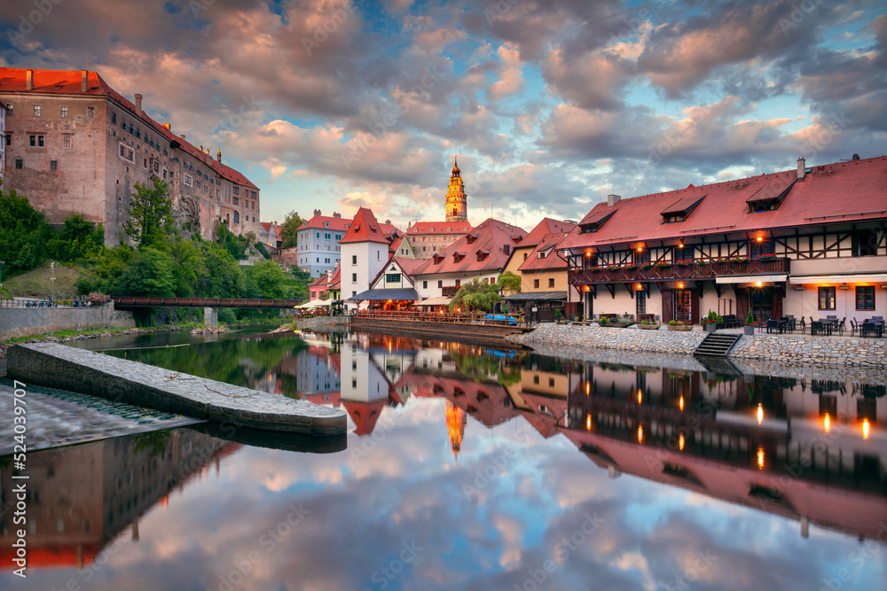Cesky Krumlov. Cityscape image of downtown Cesky Krumlov, Czech Republic with reflection of the city in Vltava River at summer sunset.