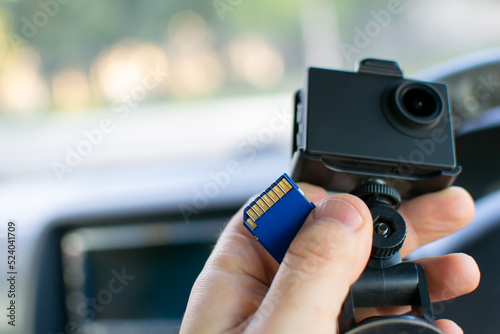 Foto a faulty flash memory card from the DVR, an action camera in the driver hands in
