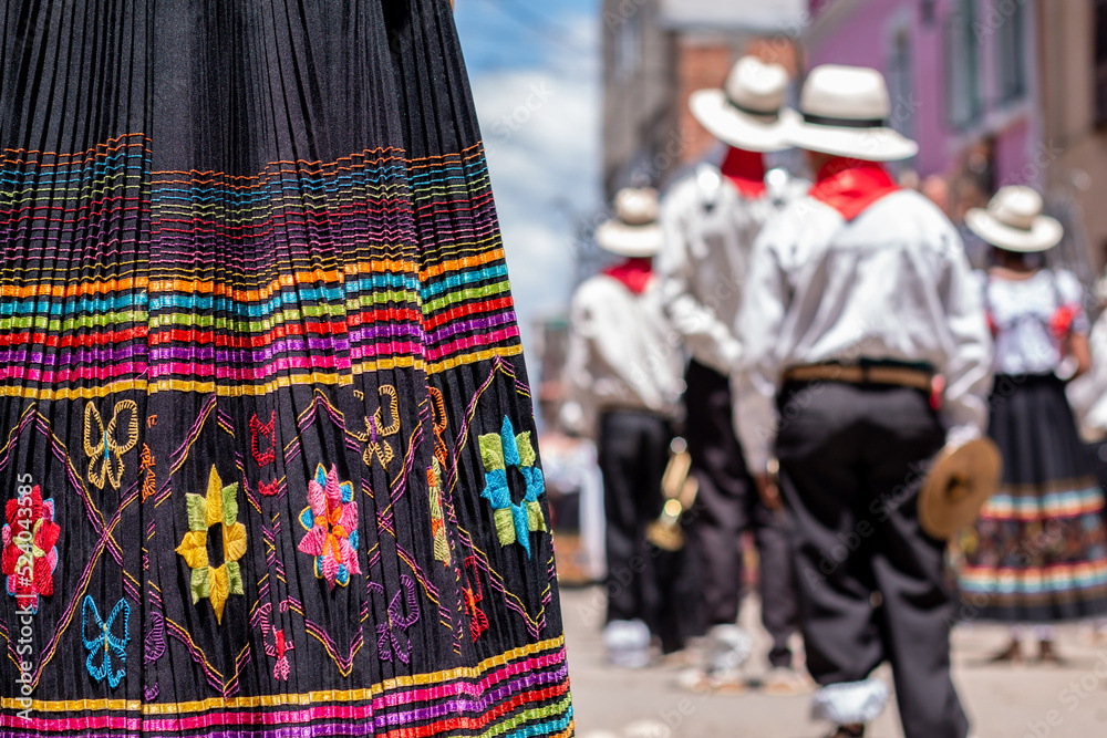 Typical colorful carnival skirt with decorations. Out of focus background of Latin American carnival
