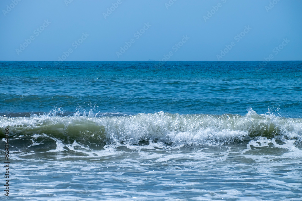 Fototapeta premium Ocean waves crashing on sandy beach. Sea waves breaking on Maditerranean's shore.