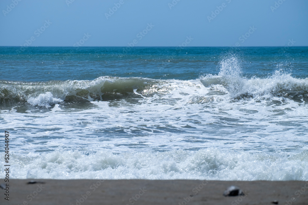 Ocean waves crashing on sandy beach. Sea waves breaking on Maditerranean's shore. Ocean waves crashing on sandy beach. Sea waves breaking on Maditerranean's shore.