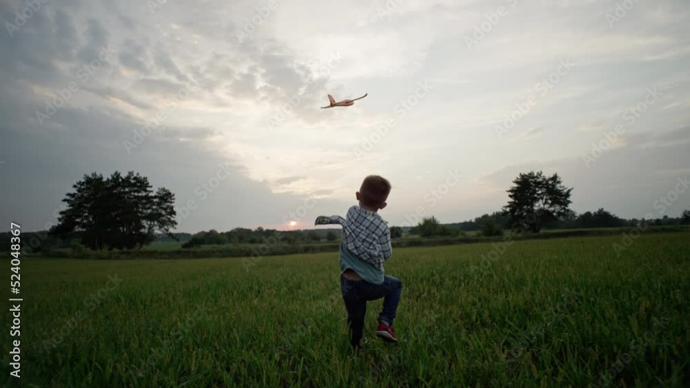 A boy launches an airplane. A child who dreams of being a pilot. Fun games in the park. A smiling and happy child. Slow motion video. High quality 4k footage A boy launches an airplane. A child who dreams of being a pilot. Fun games in the park. A smiling and happy child. Slow motion video. High quality 4k footage