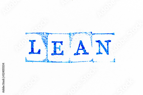 Blue color ink rubber stamp in word lean on white paper background