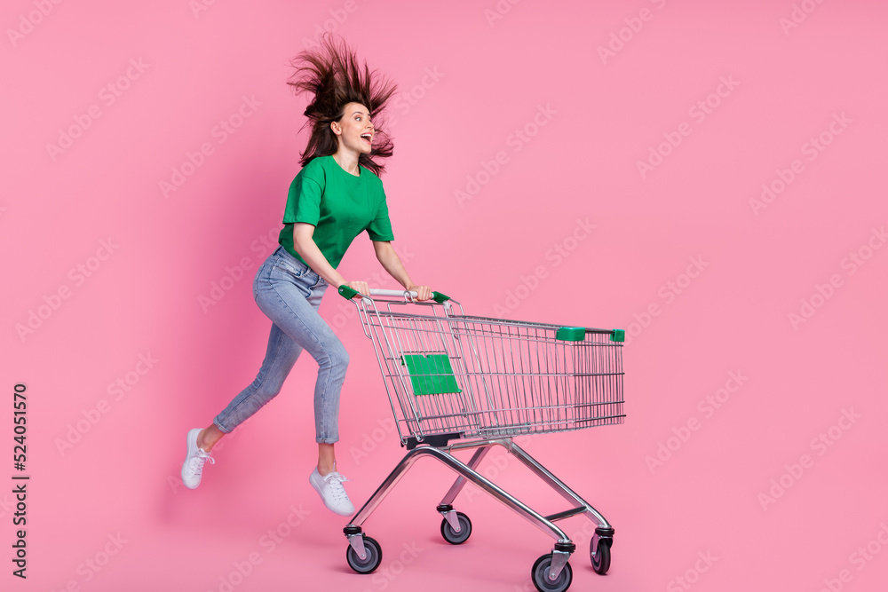 Φωτογραφία Full length portrait of excited crazy person jump run push supermarket trolley i