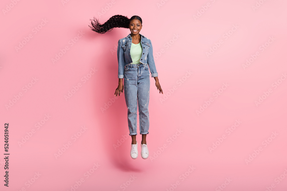 Full size photo of good mood active girl jumping up relaxing during summer vacation isolated on pink color background Full size photo of good mood active girl jumping up relaxing during summer vacation isolated on pink color background