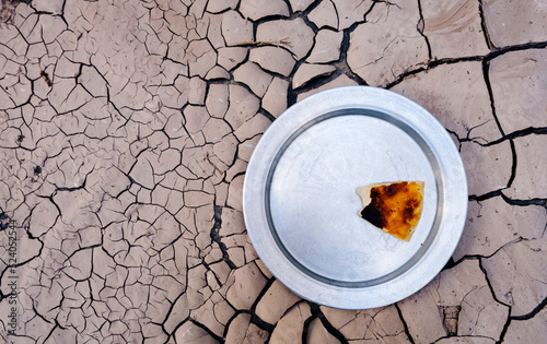 the problem of dry land and undergrown crop famine.. hunger due to famine and drought. the last piece of dry bread left on the plate.