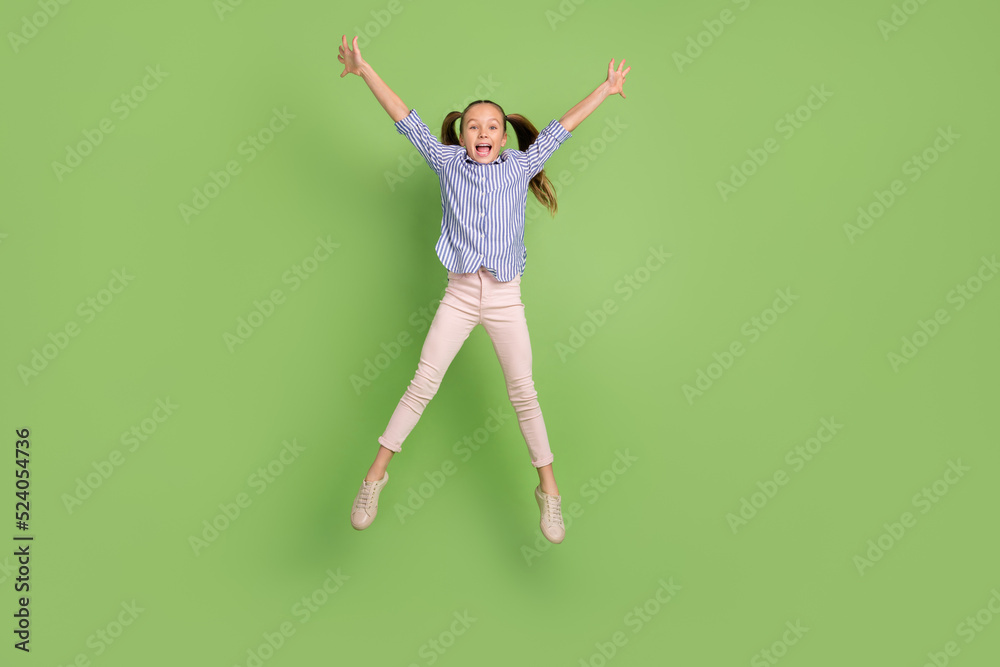 Full length photo of positive child girl jump high hands like star posing isolated shine color background
