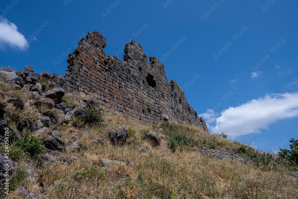 ancient stone dilapidated fortress in a picturesque place in the mountains of Armenia
