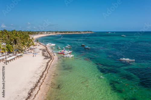 Punta Cana, Dominican Republic , view along the white sand beach of Punta Cana near Playa Bavaro with people walking on the beach - aerial view 