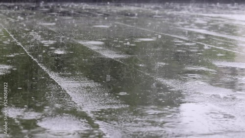 Raindrops knock on the roof, heavy rain, downpour. The flat roof of the building is covered with a waterproof material that protects from rain. Ruberoid, rolled roofing and waterproofing material.