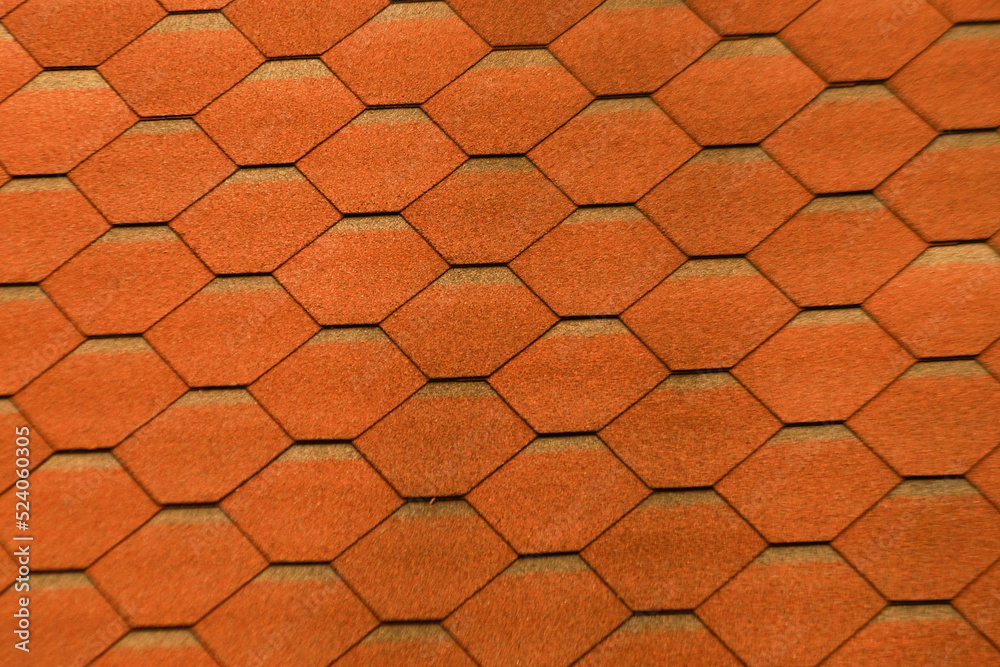 Red metal tiles on the roof of the house. Red metal tiles on the roof of the house.